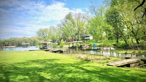 A lakeside property with a dock, a covered pavilion, and a house. - Lake Front Haven with Dual Living Rooms, Hot Tub (Mt. Juliet)
