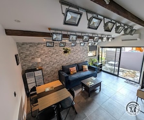 A modern living room with a sofa, coffee table, and dining area.