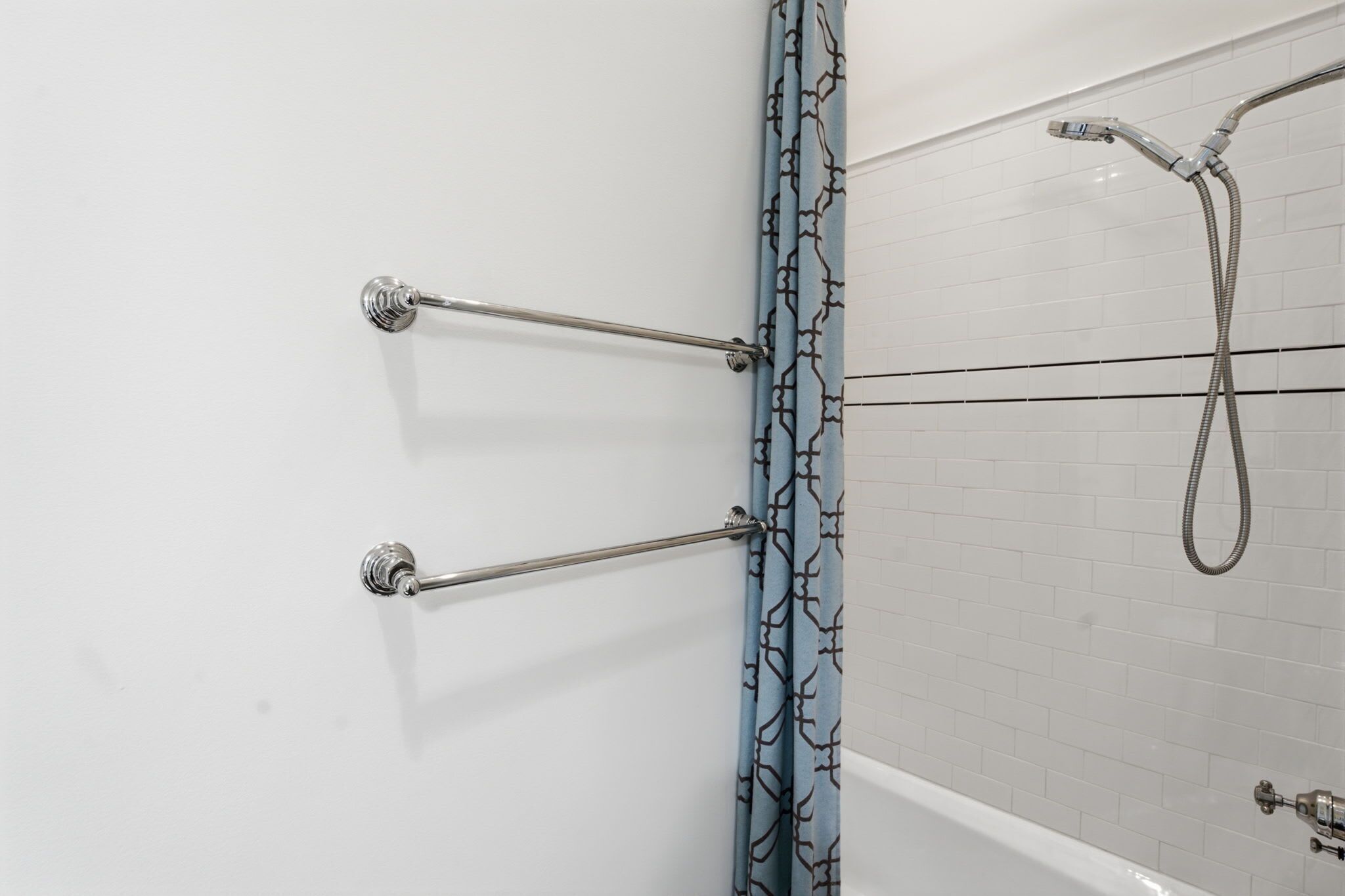 Ein Badezimmer mit Dusche, Handtuchhalter und Vorhang.