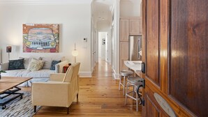 Uma sala de estar moderna com um sofá, uma mesa de centro e um quadro na parede.