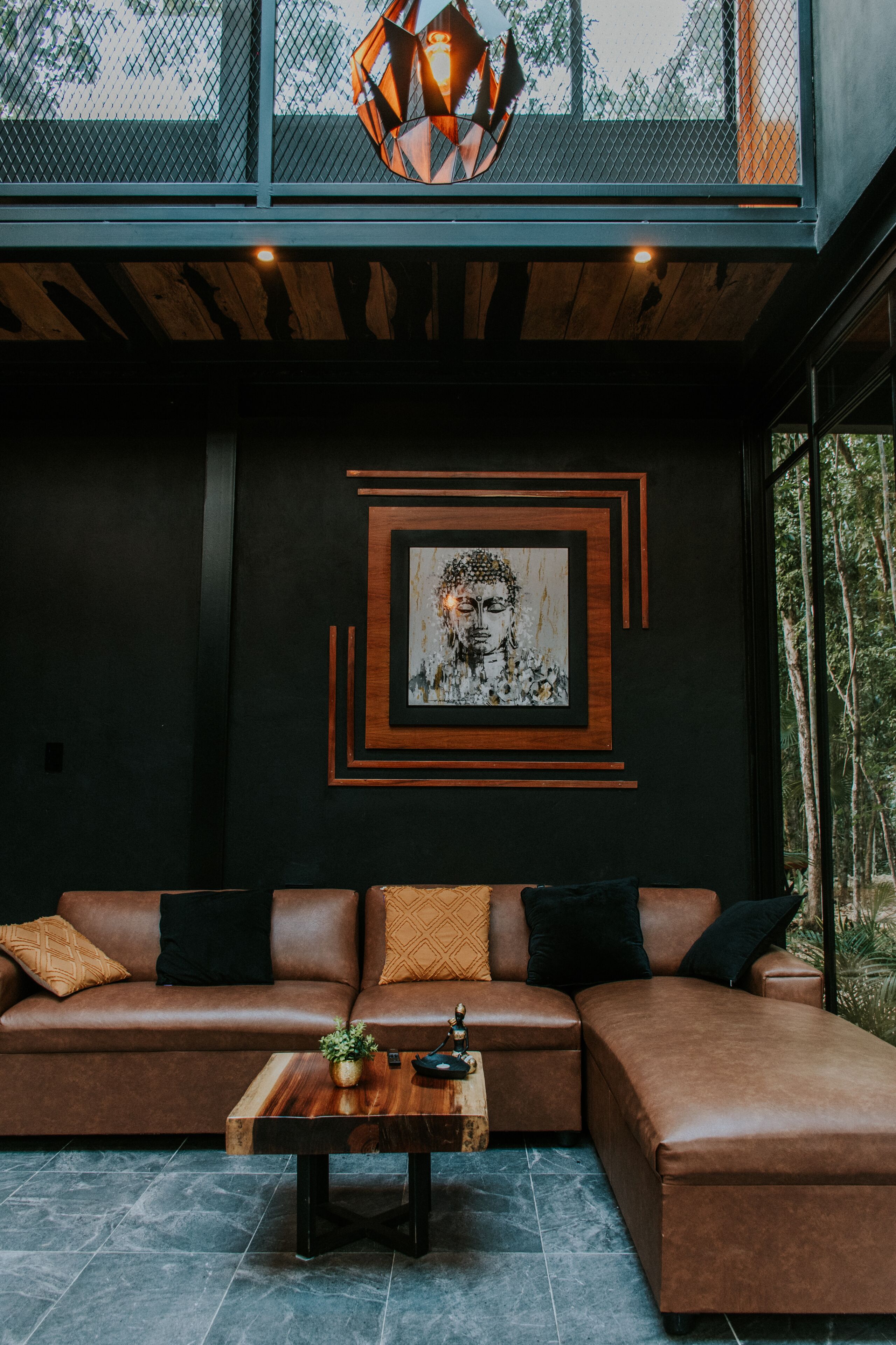 A modern living room with a sectional sofa, a wooden coffee table, and a large framed artwork on the wall.