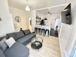 Relax in this stylish living space with a comfortable sofa and kitchen area.