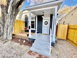 Welcome to 629, a charming home with a cozy front porch and white columns.