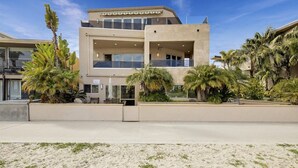 A modern hotel with a flat roof, large windows, and a covered outdoor area with palm trees. - 3526 -Bayside Walk Unit  2 (San Diego)