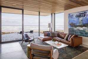 Fireplace, books, stereo - Luxury Designer Beachfront Home 3 Bed, 3.5 Bath in Arch Cape, Oregon. (Arch Cape)