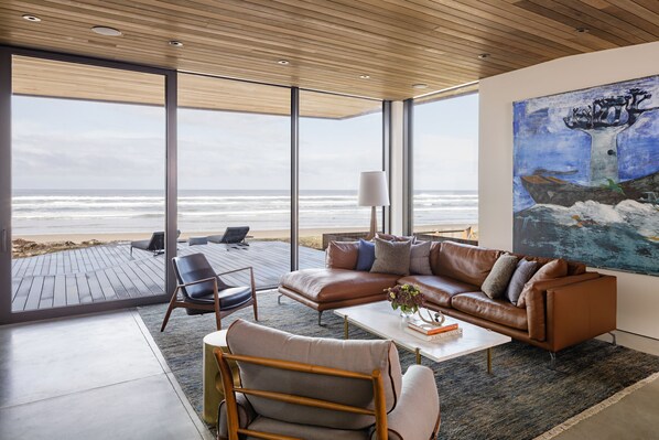 Fireplace, books, stereo - Luxury Designer Beachfront Home 3 Bed, 3.5 Bath in Arch Cape, Oregon. (Arch Cape)