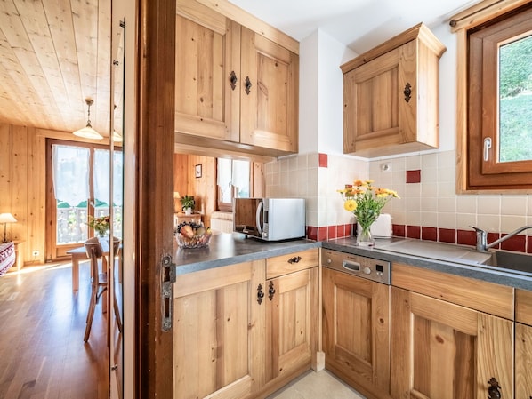 Enjoy meals in the kitchen with a large window offering a view of the outdoors.