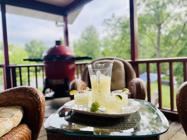 A glass table with drinks and a tray on a porch with wicker furniture and a grill in the background. - Beacon,Hudson Valley, 4bedroom 2bath, Sleeps 7, Pool, Hot Tub, Wifi,1.5m to town (Beacon)