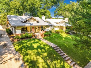 A two-story house with a front porch, a covered entryway, and a well-maintained lawn.