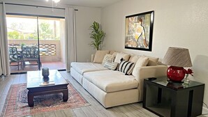 A living room with a sofa, a coffee table, a lamp, and a painting on the wall. - Excellent location,Relax in the heart of the City (Phoenix)