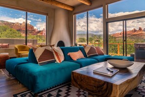 A spacious living area with a large window offering a view of red rock formations.