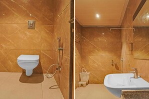 A bathroom with a toilet, shower, and sink. - The Park Celebration (Surat)