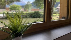 A room with a sliding glass door leading to a garden. - Ilse EG Süd-West by Interhome (Fiesch)
