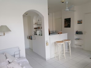 Cozy living space with a sofa, dining area, and kitchenette.