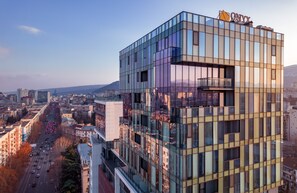 A modern building with a glass facade and a visible sign that reads "ONYX". -  Onyx City Center (Tbilisi)