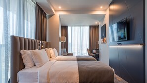 A modern hotel room with a large bed, a desk, and a TV. -  Onyx City Center (Tbilisi)