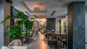 A modern restaurant with high ceilings, ambient lighting, and potted plants. -  Onyx City Center (Tbilisi)