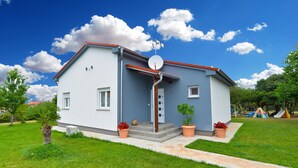 A two-story house with a satellite dish, a small porch, and a play area in the background. - House 2177/55666 (Istria - Pula), 2500m from the beach (Pula)