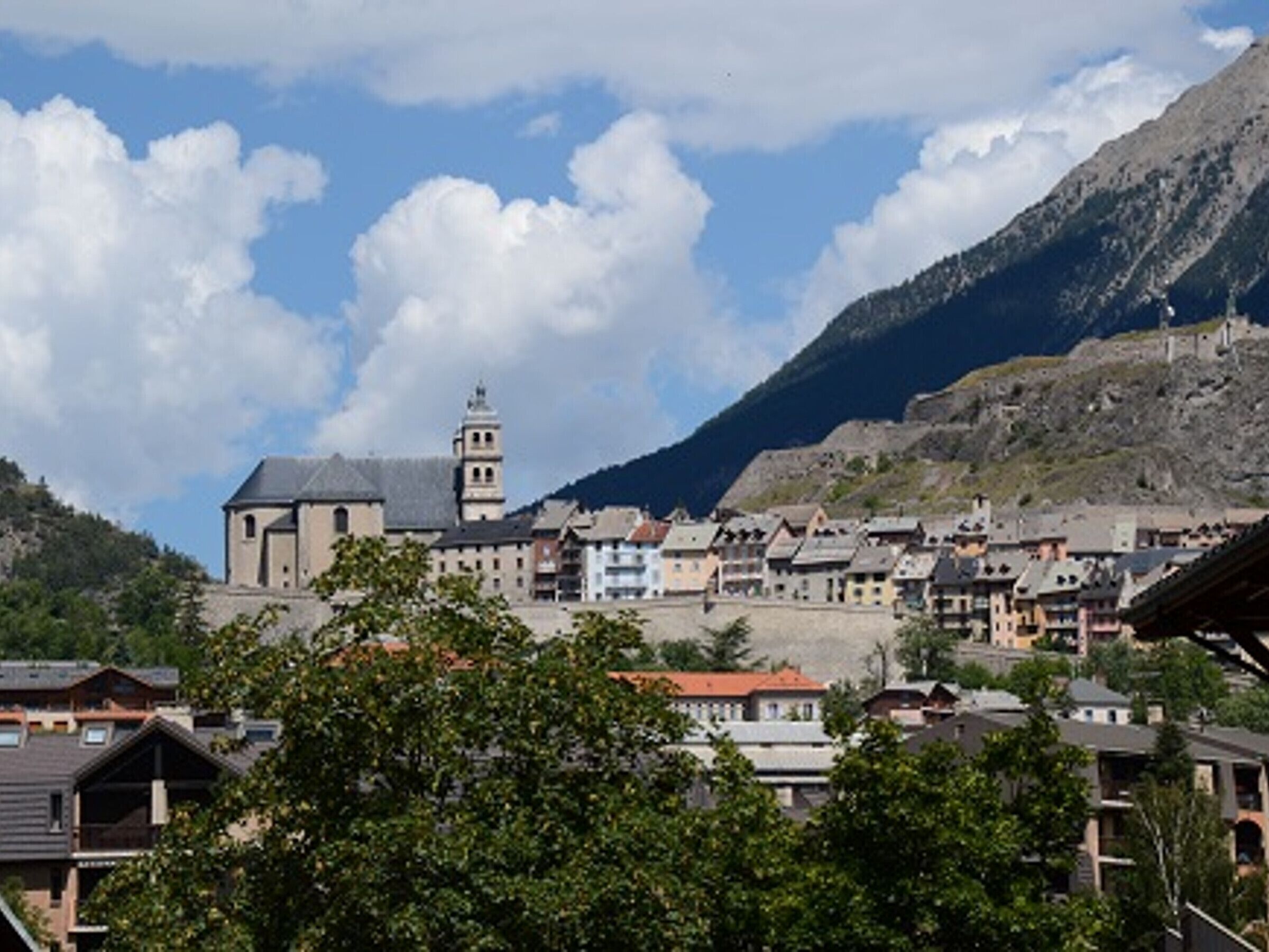 A town with a prominent church and a mountain backdrop.