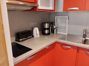 A compact kitchen with a toaster, coffee maker, and a microwave. - Renovated 2-room apartment, balcony, pets allowed, parking (La Plagne Montchavin Les Coches)