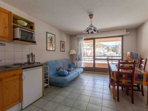Cozy living space with a kitchenette, sofa, and dining area, perfect for a comfortable stay.