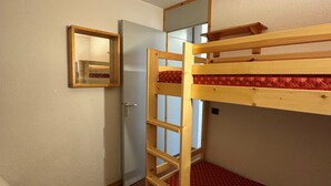 A bunk bed room with a wooden ladder, a door, and a mirror on the wall. - Apartment with balcony and direct slope access, pets allowed (Belle Plagne)