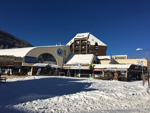 A building with multiple storefronts, including a bowling alley and a bar.