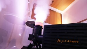 A room with a ceiling-mounted projector and a ventilation unit. - First Cabin Nishi Umeda (Osaka)