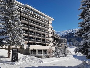Hotel features a modern design with spacious balconies on each floor, offering stunning views of the surrounding mountains.