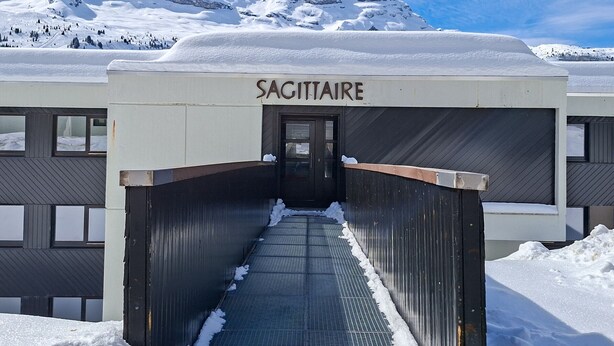 A building entrance labeled 'SAGITTAIRE' with a metal staircase leading up. - Renovated studio in Flaine center with balcony for 5 people (Flaine)
