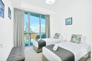 Enjoy a city view from the comfort of this stylish room, featuring two single beds and a spacious desk area.