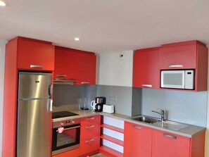 A compact kitchen with a stainless steel refrigerator, a microwave, a toaster, and a sink. - Bright Apartment · Near Slopes · Balcony · Pets Allowed (La Plagne Montchavin Les Coches)