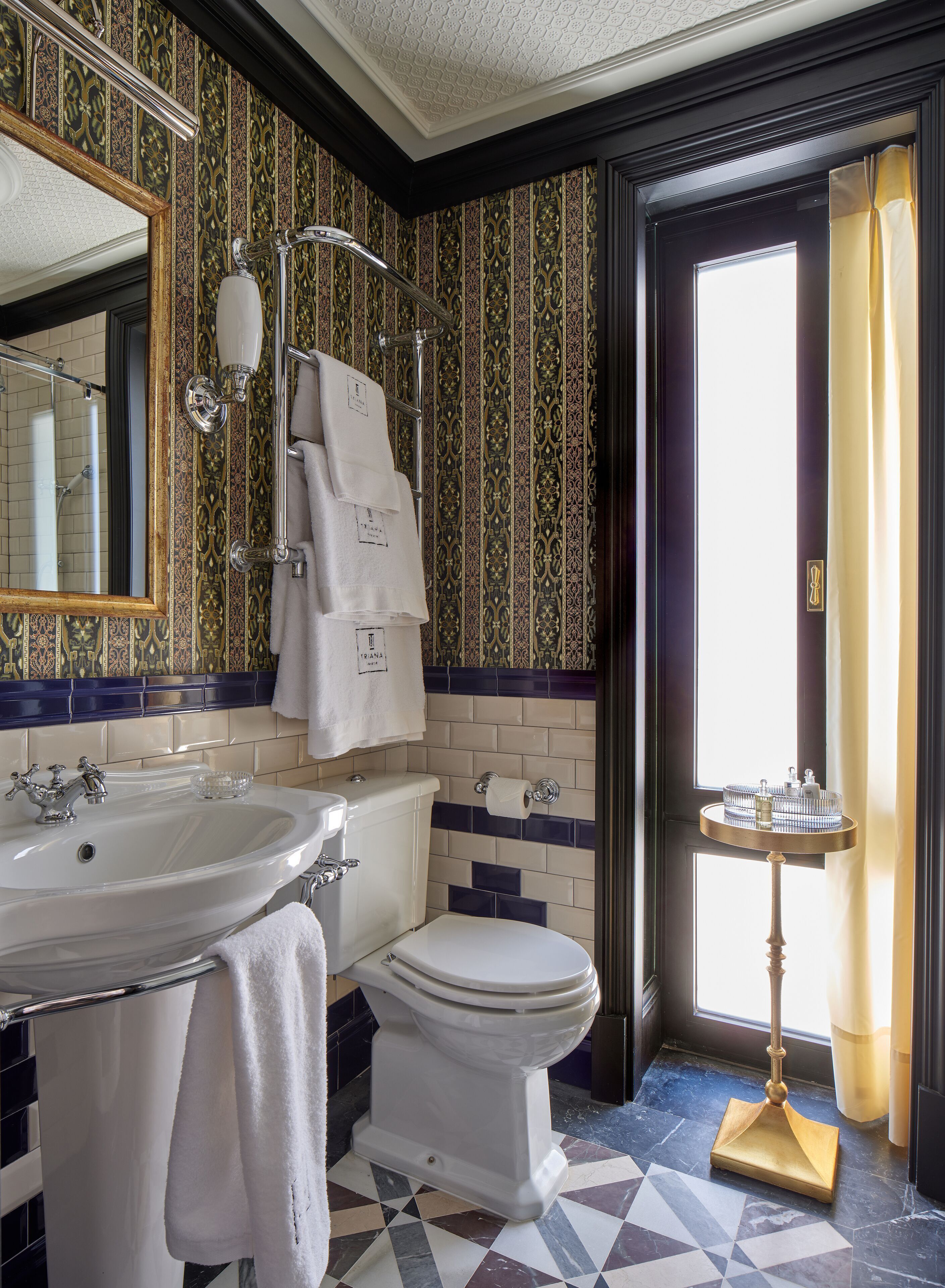 A bathroom with a sink, toilet, and mirror.