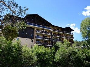 A multi-story hotel with balconies, surrounded by greenery. - Renovated studio near slopes with wifi, pets allowed (Briançon)