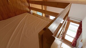 A wooden room with a bunk bed, a window with curtains, and a wooden ceiling. - Spacious apartment 5 guests · Ski-in/ski-out · Balcony with views (Belle Plagne)