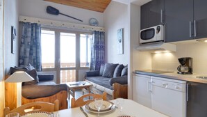 A compact kitchen with a microwave, coffee maker, and white cabinets. - Renovated apartment at slopes with balcony (Belle Plagne)