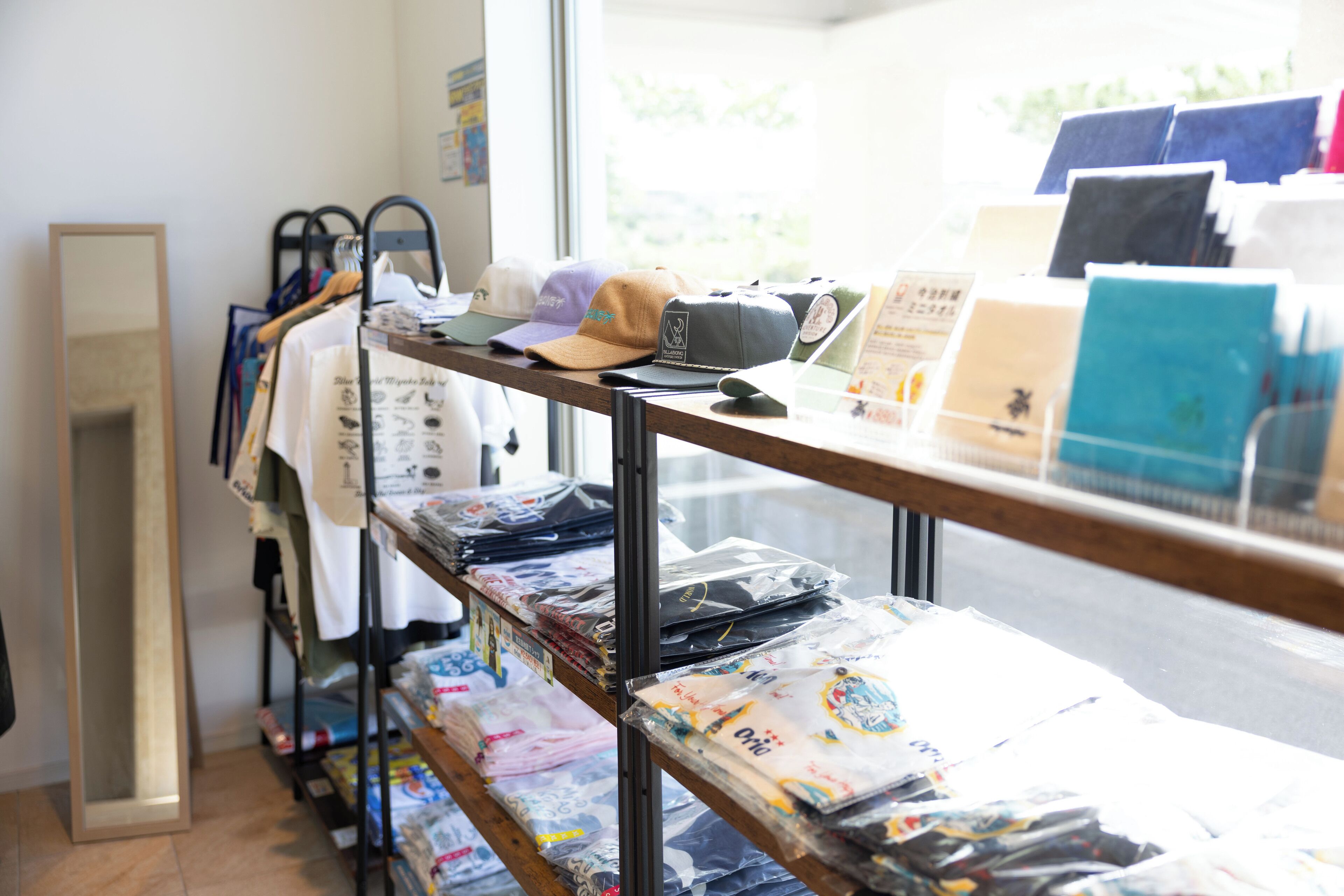A retail display with various hats and bags.