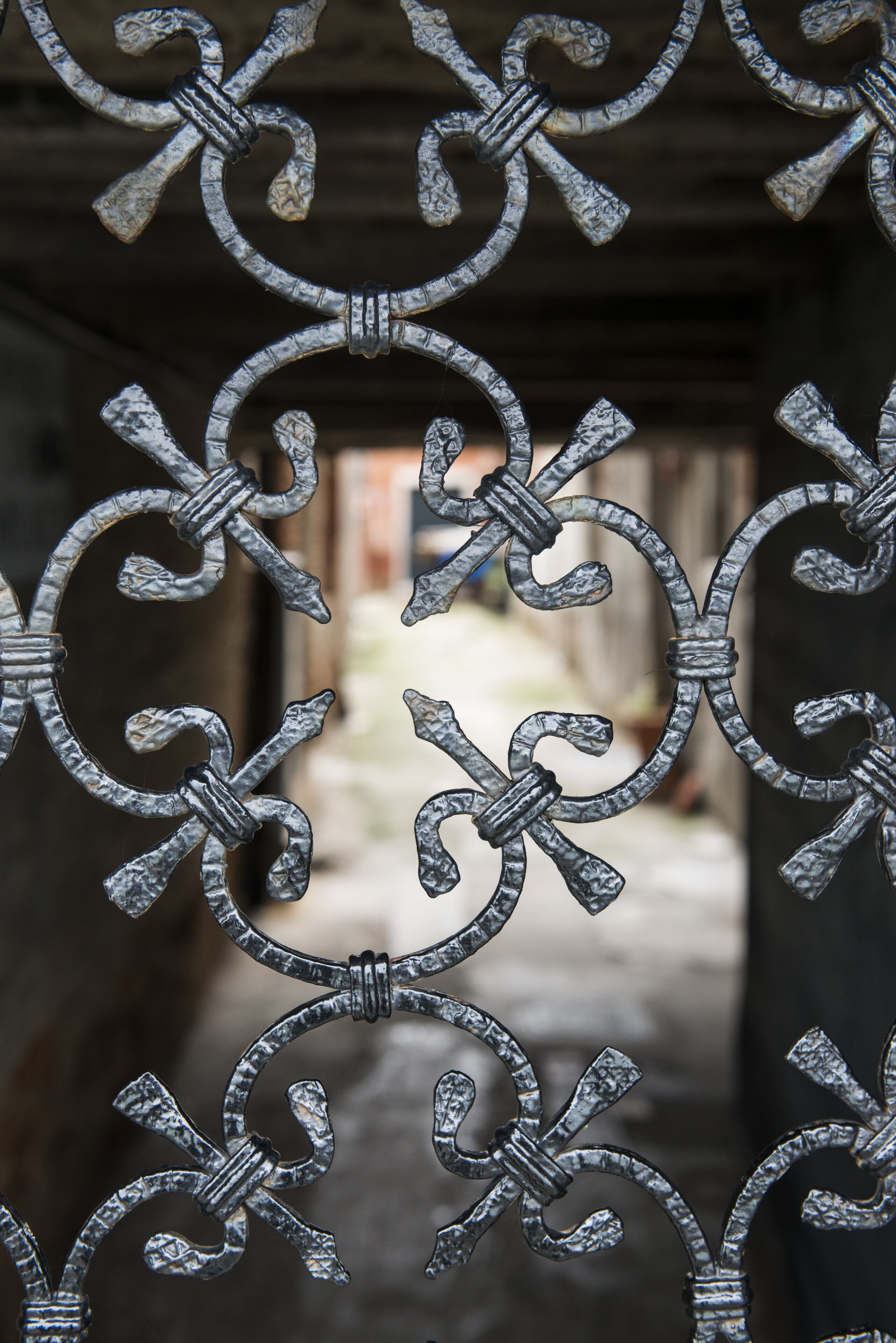 A close-up of ornate metalwork with a symmetrical design, featuring interlocking loops and a central knot.