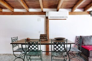 A dining area with a wooden table, four chairs, a bowl, and a decorative box.