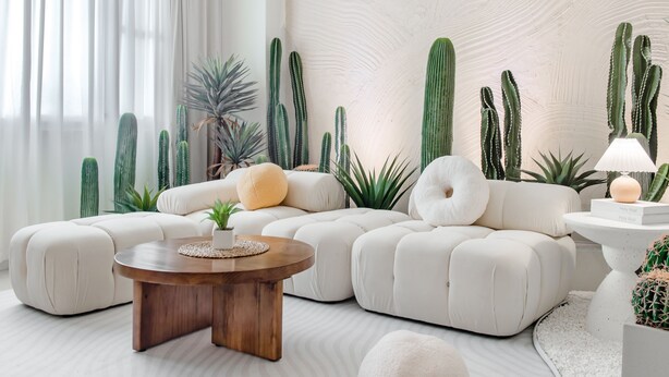 A modern living room with a sectional sofa, a wooden coffee table, and a cactus wall. - Pet Friendly Taitung Chun Yang Smart Stay (Taitung)