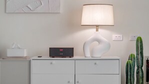 A bedside table with a lamp, a tissue box, a digital clock, and a cactus plant. - Pet Friendly Taitung Chun Yang Smart Stay (Taitung)