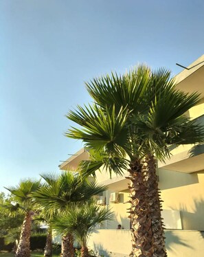 A modern building with a flat roof and a balcony.