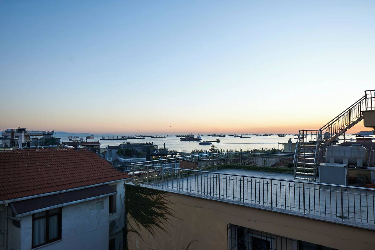 A coastal cityscape with a view of the sea and ships.