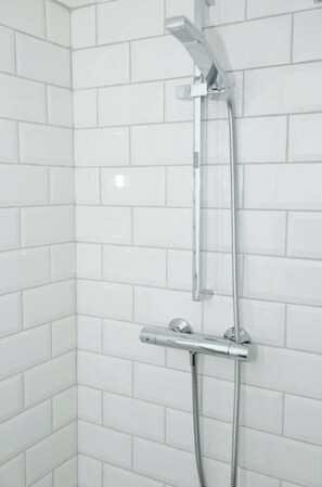 Bathtub, hair dryer, towels, toilet paper