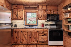 Fridge, microwave, oven, stovetop - Twin Creeks Cabin - RIVER FRONT! *Hot tub* 4 acres! Pets OK (Deep Gap)