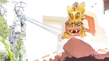 A building with a lion head sculpture on top.