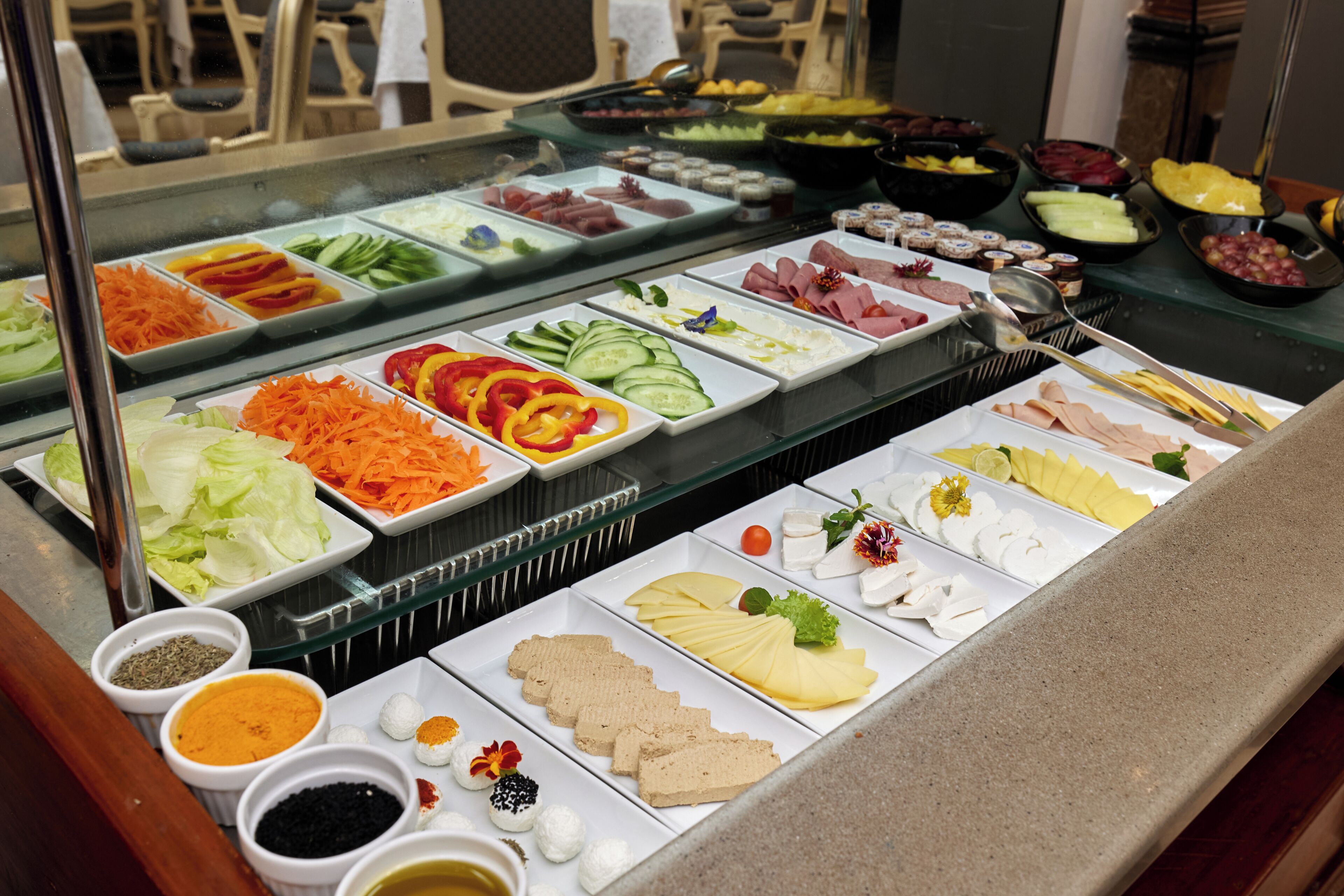 A buffet with various food items and condiments.
