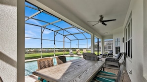 A covered patio with a pool, outdoor furniture, and a ceiling fan. - Last Minute Disney! Private Pool, Hot Tub, Game Room & Themed Bedrooms. Book Now! #1314 (Orlando)