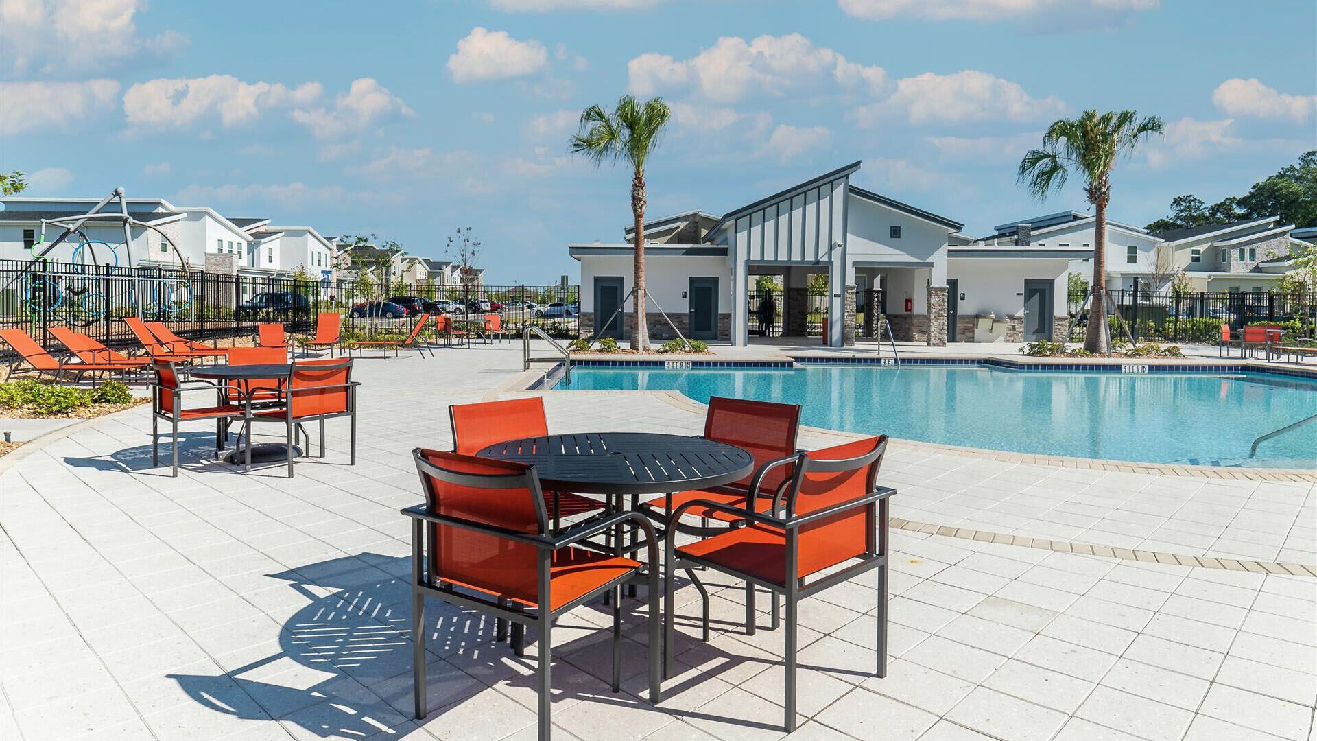 A poolside area with outdoor seating and a swimming pool.