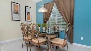 Enjoy meals in this stylish dining area with a glass-top table and comfortable seating for four.